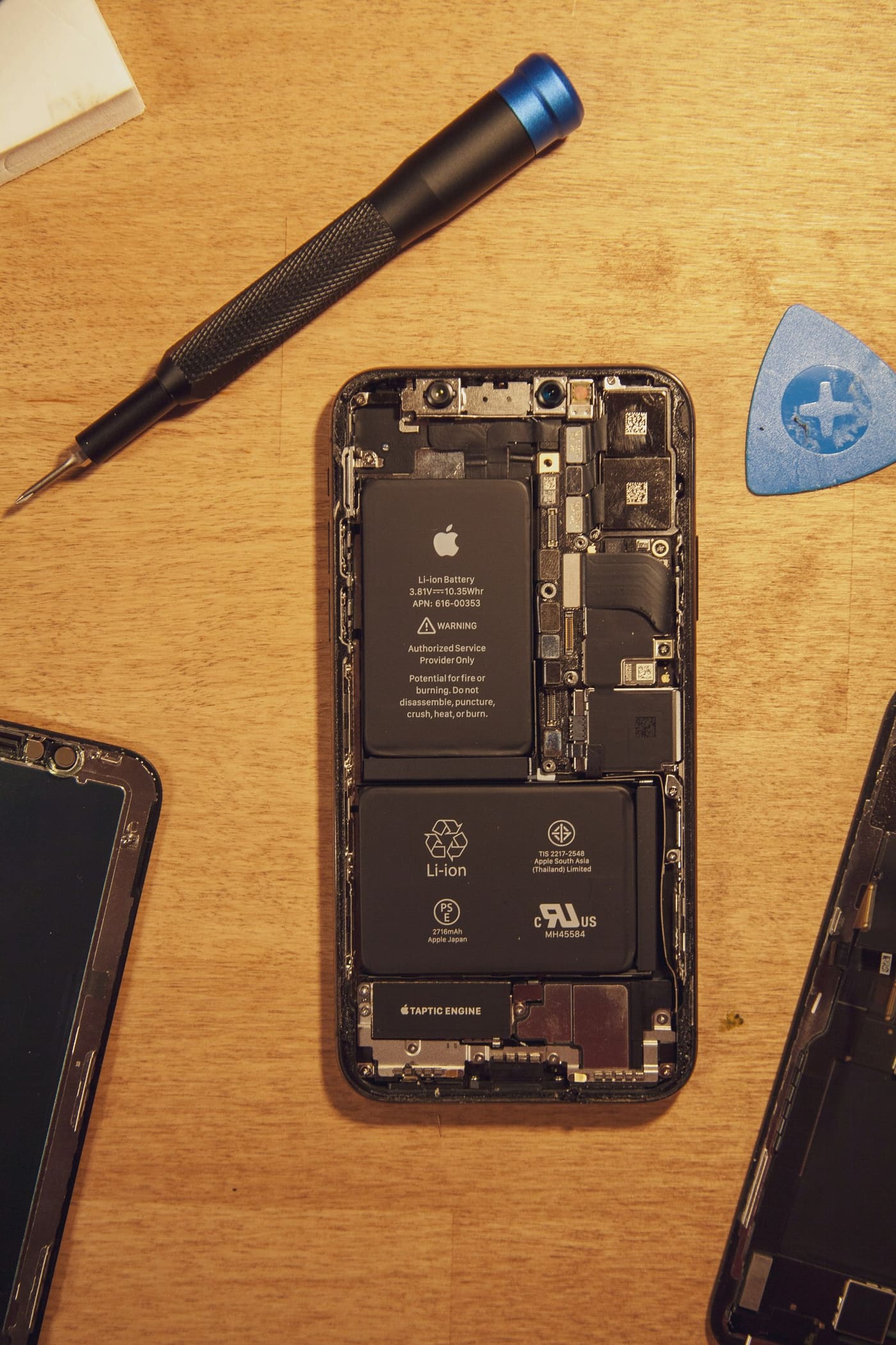 Technician replacing a cracked phone screen